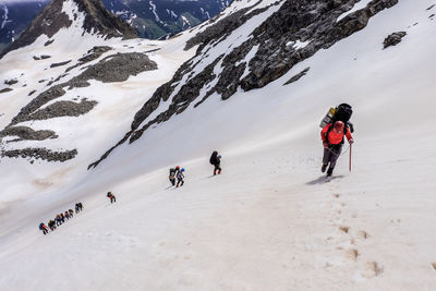 People skiing on snowcapped mountain