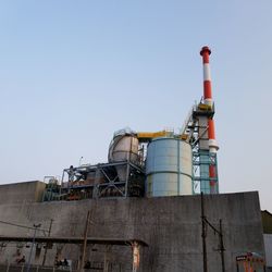 Low angle view of factory against clear sky