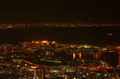 High angle view of illuminated buildings against sky at night