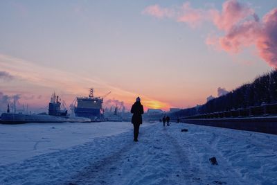 People standing on snow covered landscape