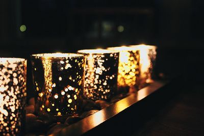 Close-up of illuminated candles on table