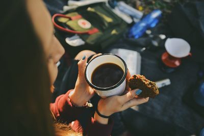 High angle view of woman holding coffee cup