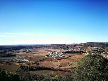 High angle view of field against clear blue sky