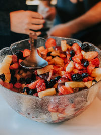 Close-up of hand with fruit salad