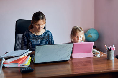 Woman mother working doing her job remotely during video chat call stream online course webinar