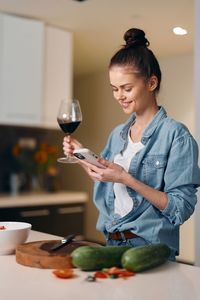 Young woman holding wineglass