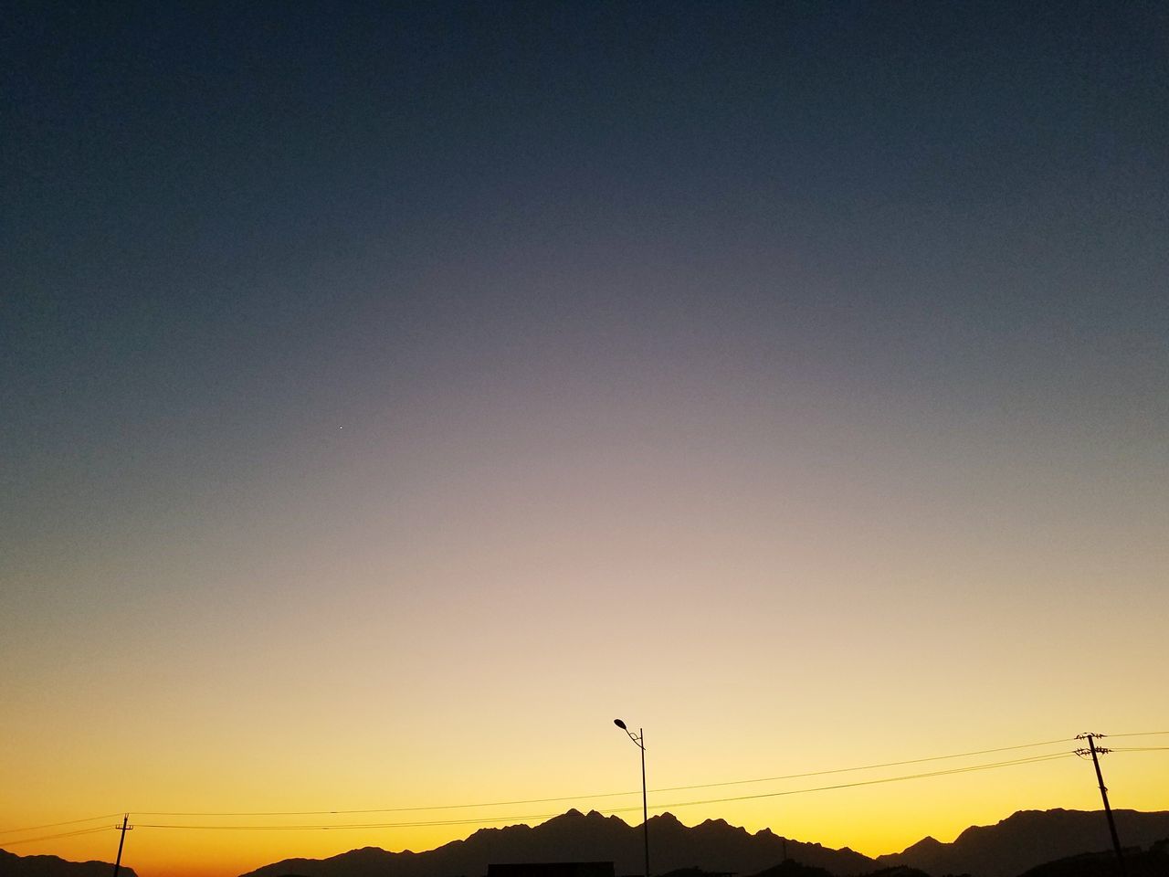 POWER LINES AGAINST SKY DURING SUNSET