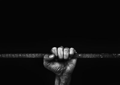 Close-up of human hand against black background