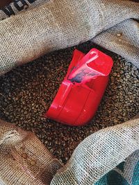 High angle view of red wine on sand