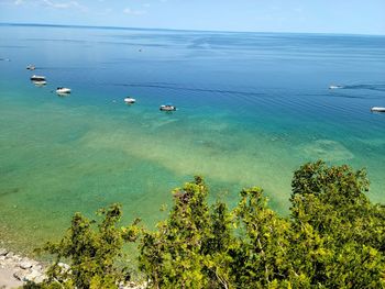 High angle view of sailboats in sea against sky