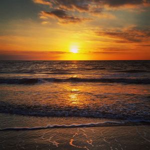 Scenic view of beach against sky during sunset