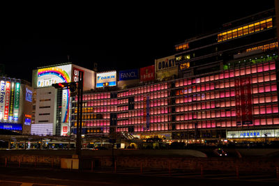 Illuminated city against sky at night