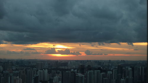 Cityscape against cloudy sky
