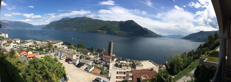 High angle view of town by sea against sky