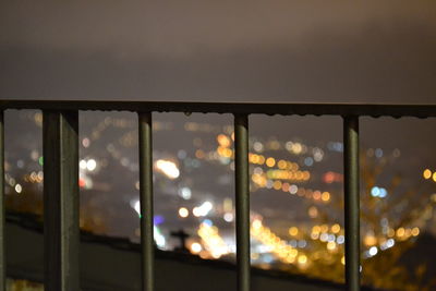 Close-up of illuminated lights against sky at night