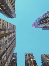 Low angle view of modern buildings against clear blue sky