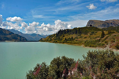 Scenic view of lake and mountains against sky