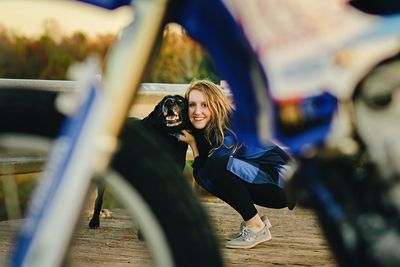 Full length of happy young woman with dog