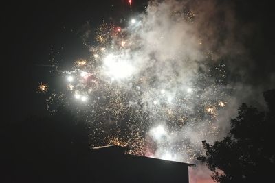 Low angle view of firework display at night