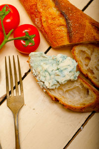 Fresh blue cheese spread ove french baguette with cherry tomatoes on side