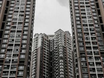 Low angle view of modern buildings in city against sky