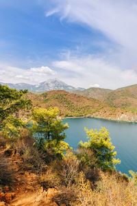 Scenic view of lake and mountains against sky