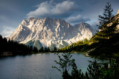 Scenic view of lake and mountains against sky