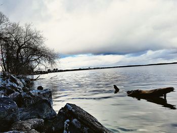 Scenic view of lake against cloudy sky