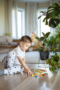 Portrait of cute baby boy sitting on table