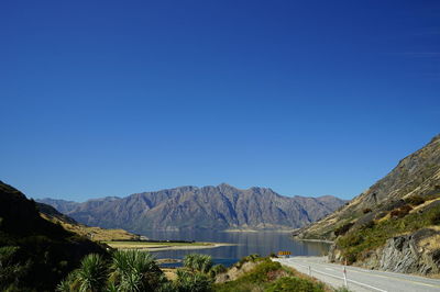 Scenic view of mountains against clear blue sky