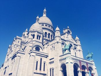 Low angle view of building against clear blue sky