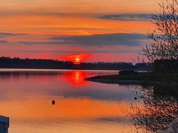 Scenic view of lake against romantic sky at sunset