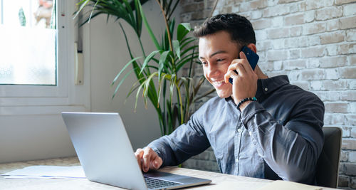 Young man using laptop at office