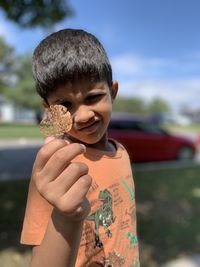 Portrait of boy standing outdoors