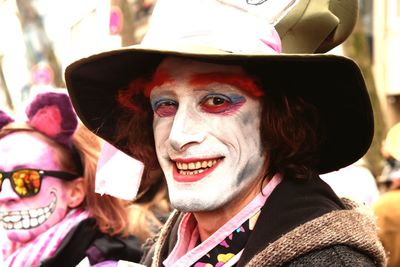 Close-up portrait of smiling man with face paint during carnival