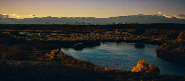 Scenic view of lake against sky during sunset