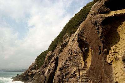 Scenic view of rock formation in sea against sky