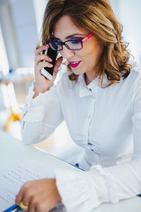 Midsection of woman using mobile phone