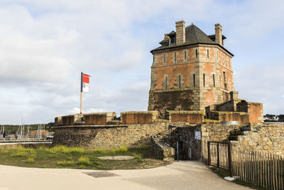 View of old building against cloudy sky