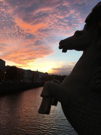 Close-up of silhouette statue against sky during sunset