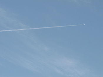 Low angle view of vapor trails in sky