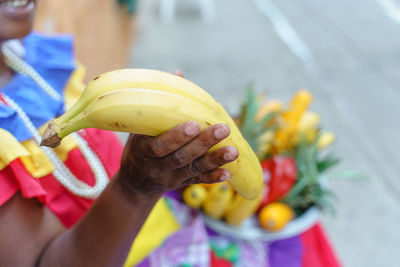 Midsection of woman holding apple on flower