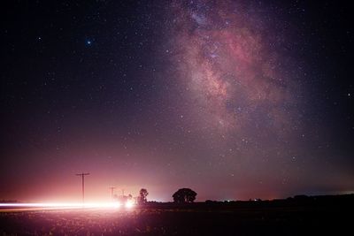 Long exposure shot of milky way while car passes giving slight beem of light