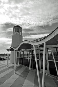 Buildings against cloudy sky