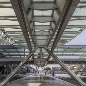 Low angle view of footbridge in city