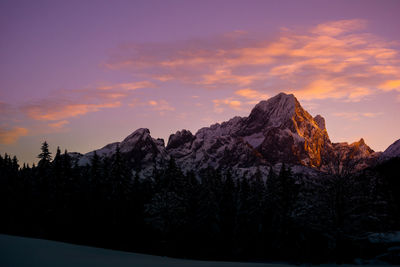 Scenic view of snowcapped mountains against sky during sunset