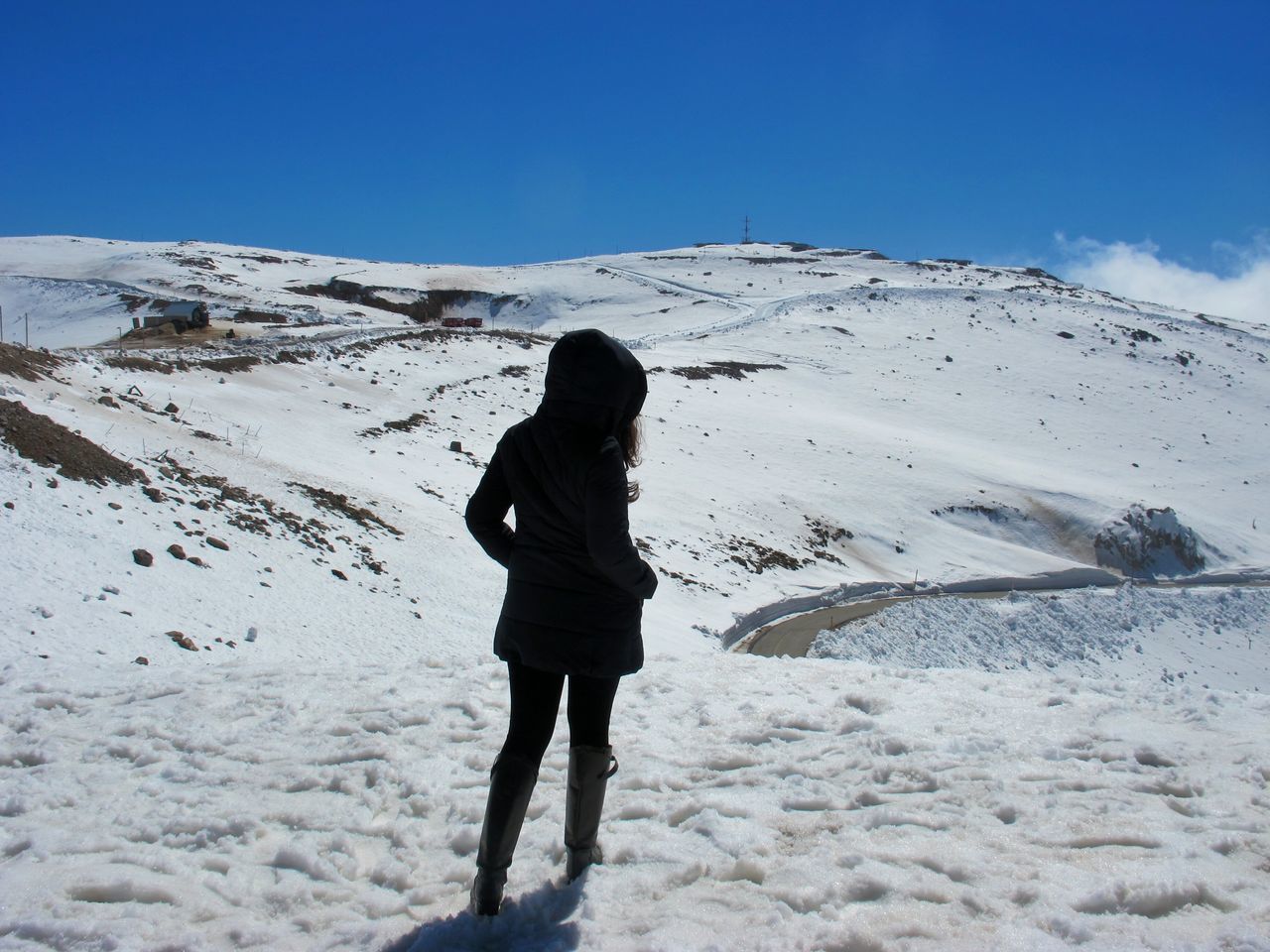 snow, winter, cold temperature, season, full length, lifestyles, leisure activity, rear view, weather, warm clothing, standing, tranquil scene, tranquility, blue, clear sky, landscape, walking, mountain