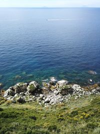 High angle view of rocks on sea against sky