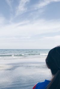 Rear view of woman standing on beach