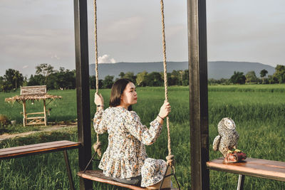 Woman sitting by plants